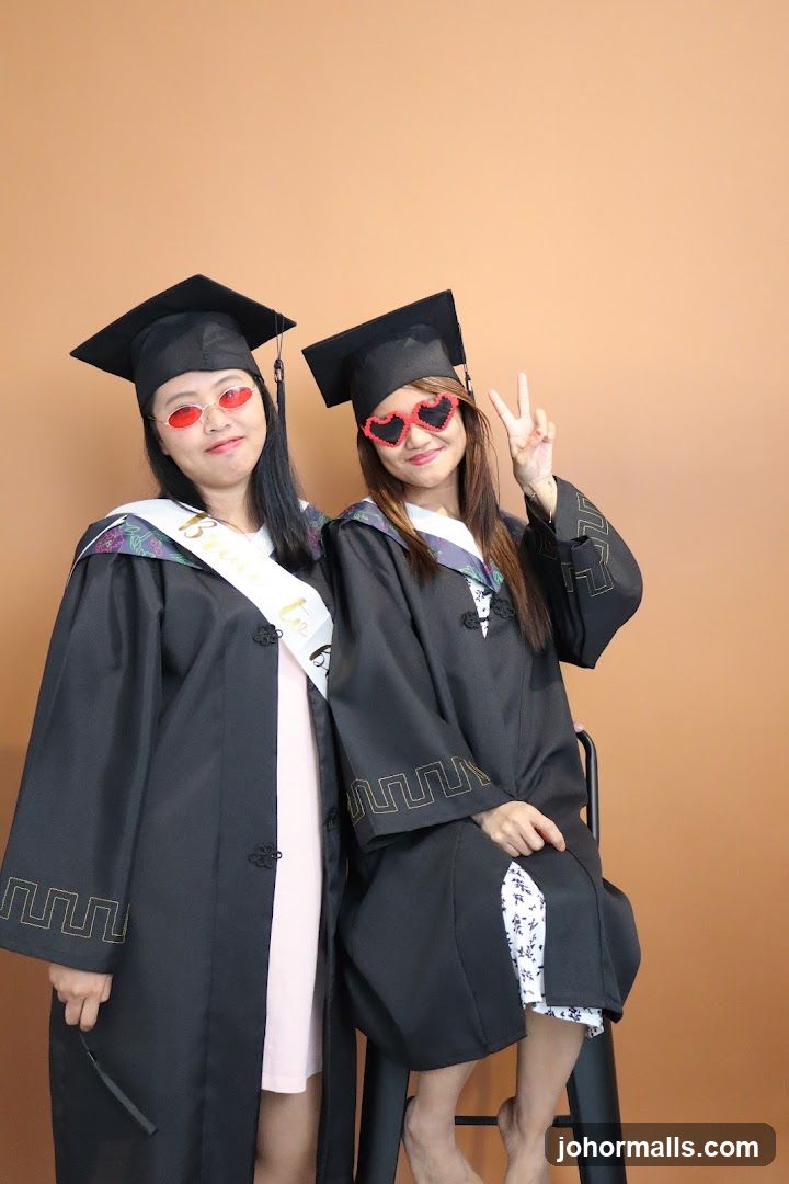 Two graduates posing for a photo