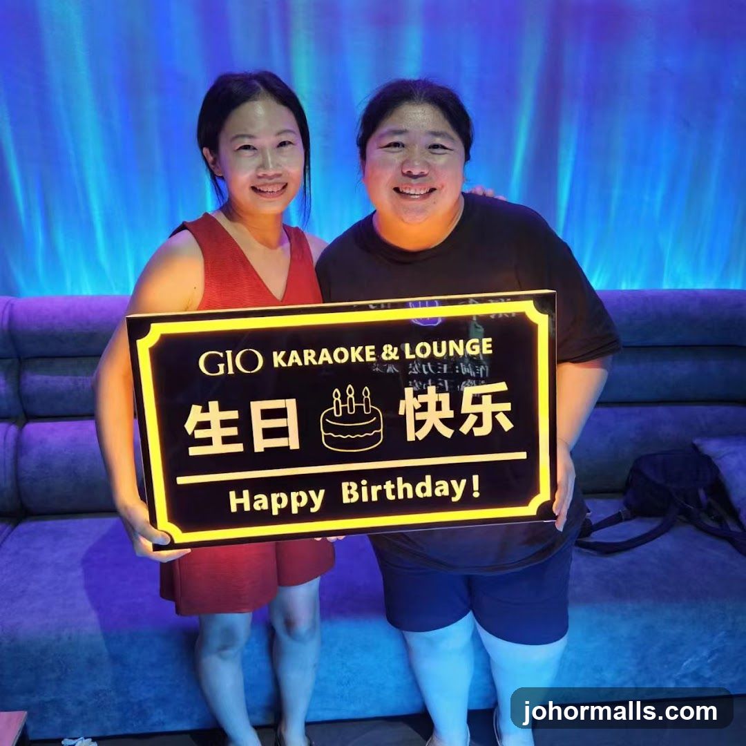 Two Women Holding a Happy Birthday Sign