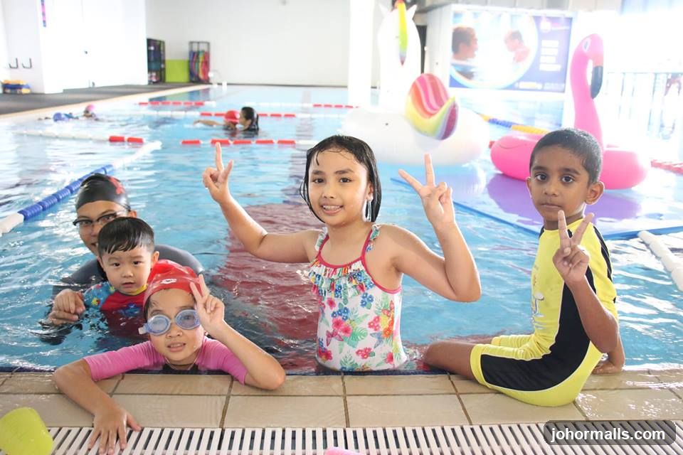 Children posing in a swimming pool