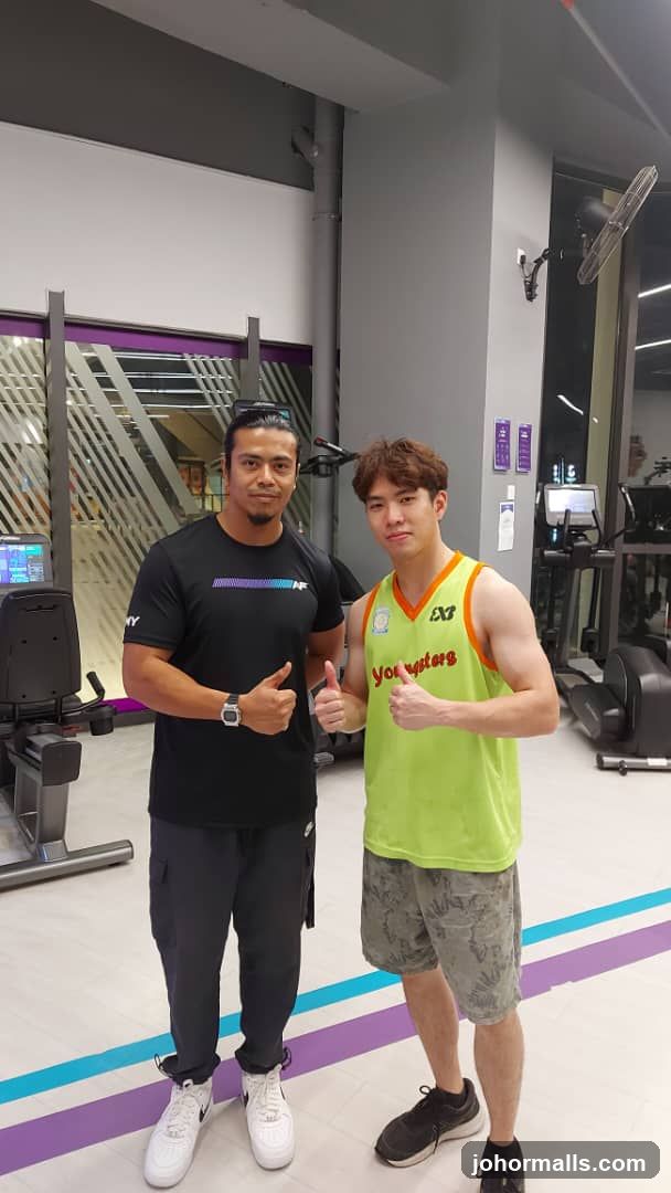 Two men posing in a gym