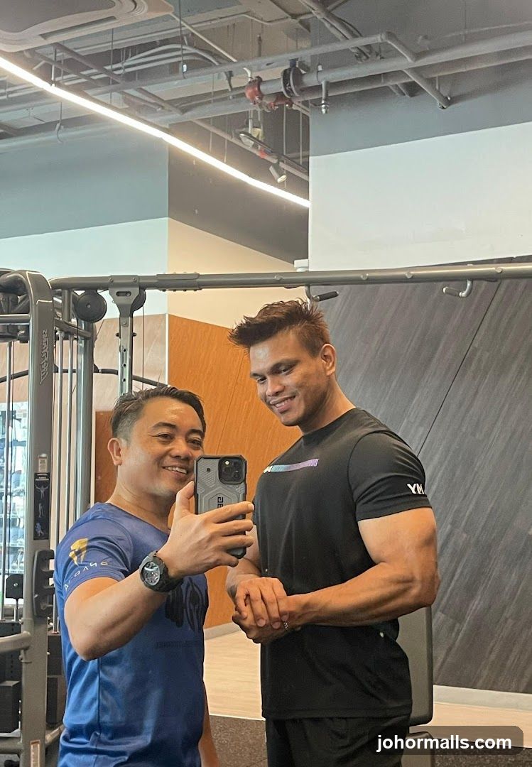 Two men taking a selfie in a gym