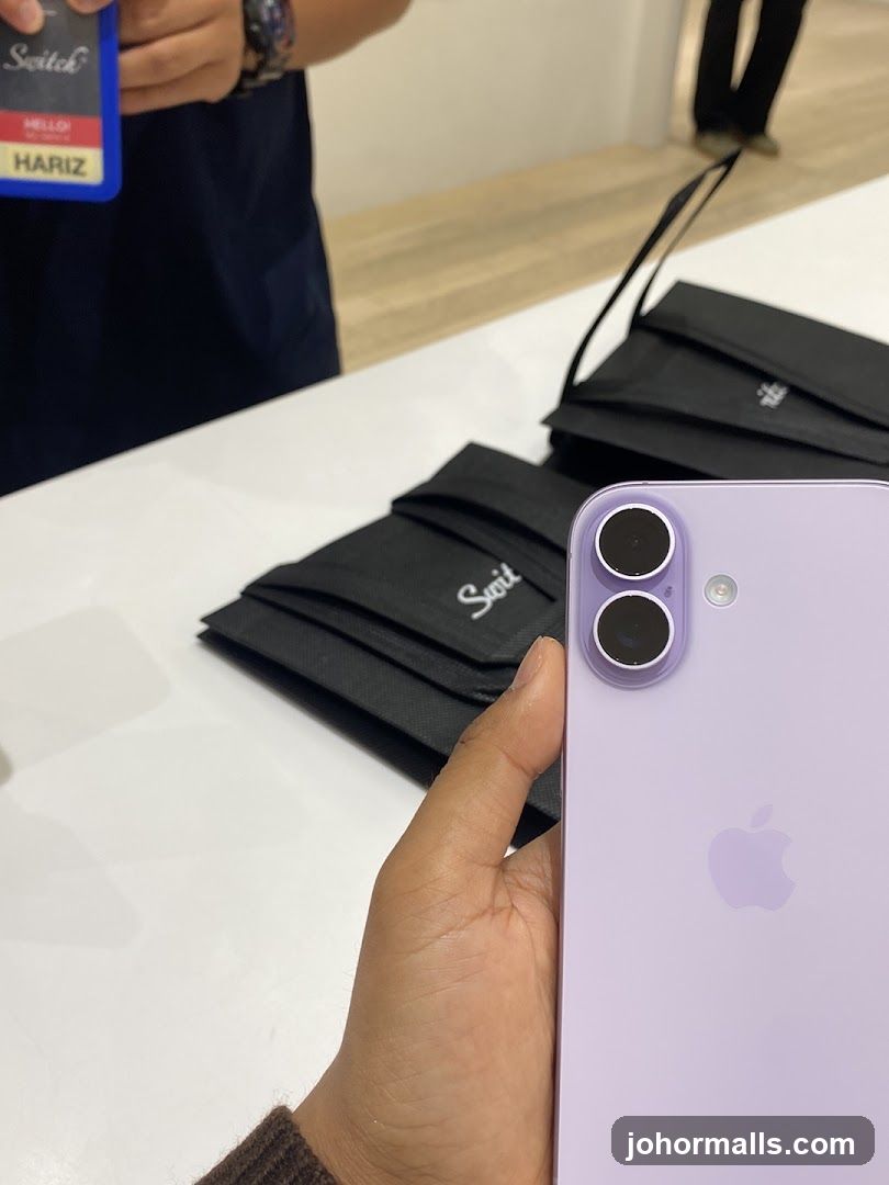 Person holding a purple iPhone