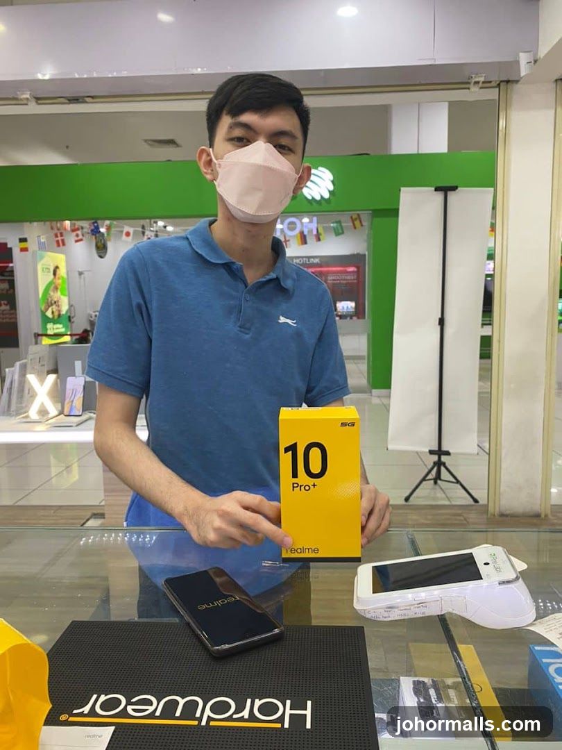 Man holding a Realme phone box