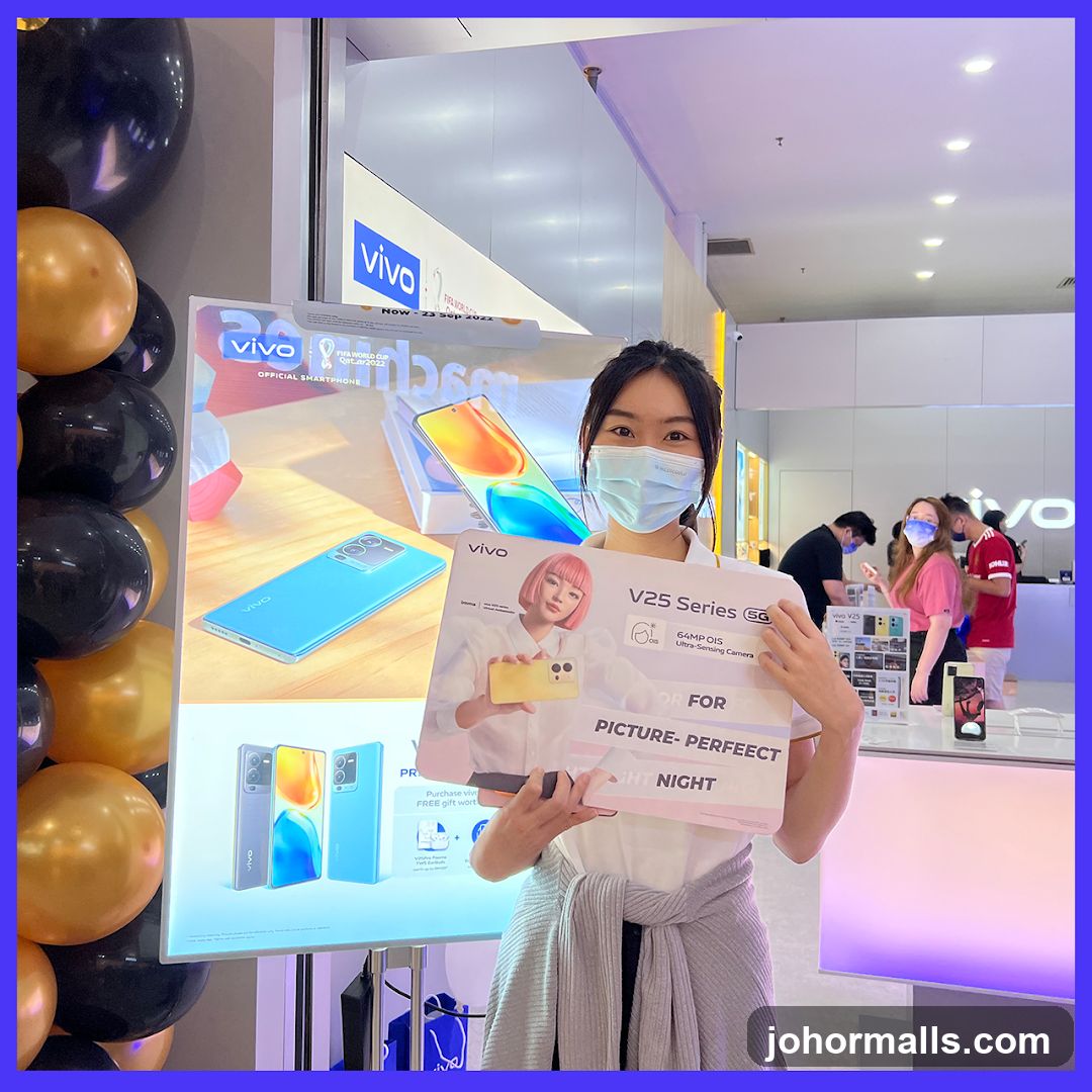 Woman holding a Vivo V25 Series 5G promotional sign