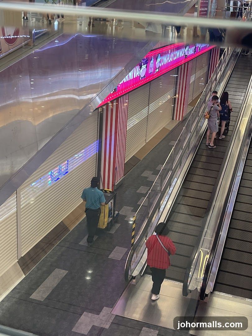Escalator in a mall with a colorful advertisement