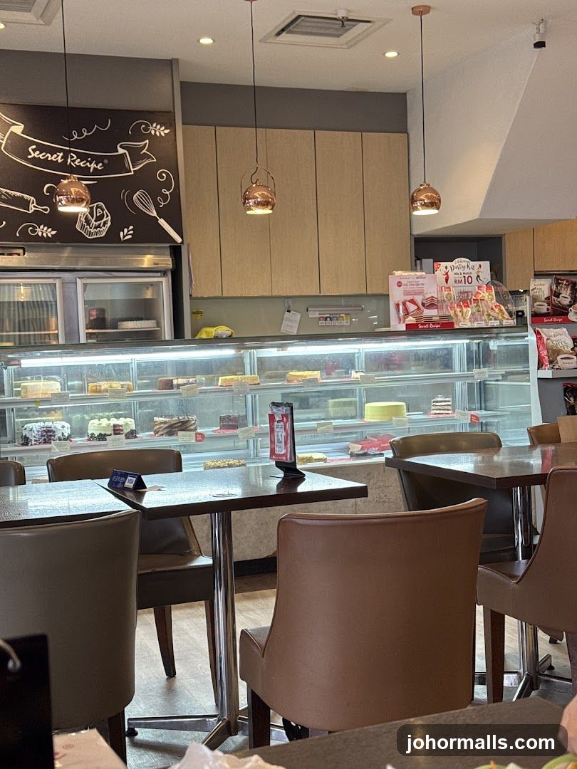 Interior of a cafe with display cases of cakes