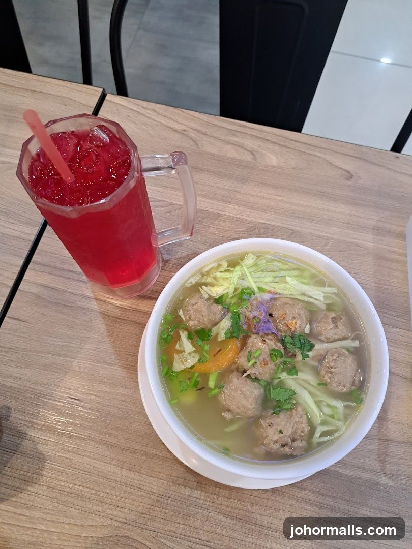 Bowl of Meatball Soup and Red Drink