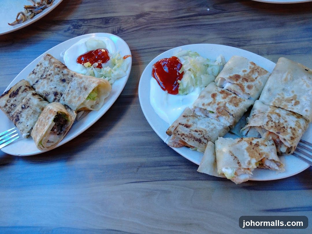 Two plates of wraps with sides