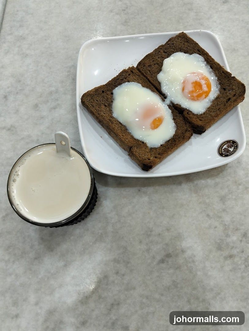 Soft-boiled eggs on toast with a drink