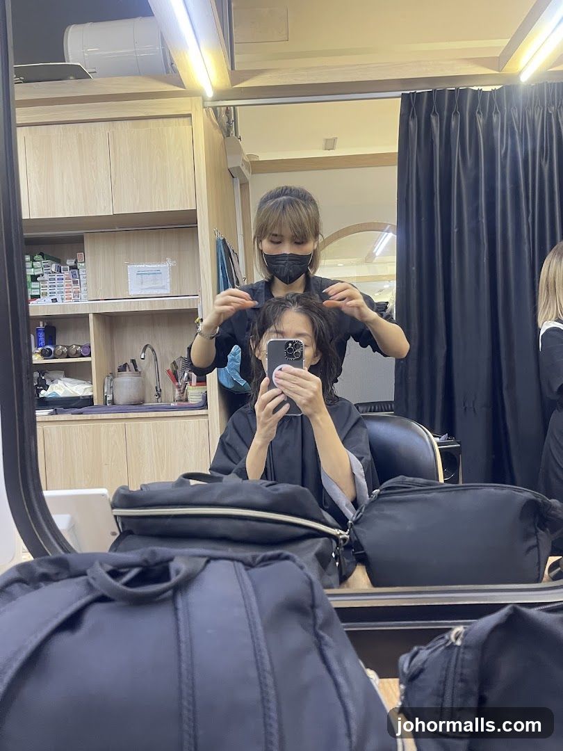 Hairdresser styling client's hair