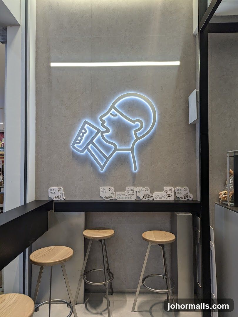 Tea shop interior with neon sign and stools