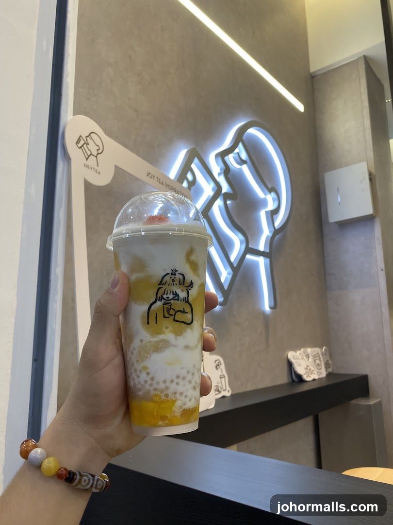Person holding a beverage in a cafe
