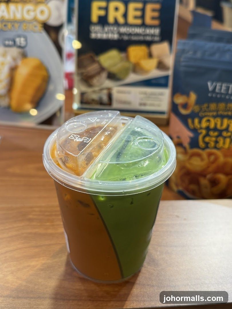 Two-toned drink with promotional posters in the background