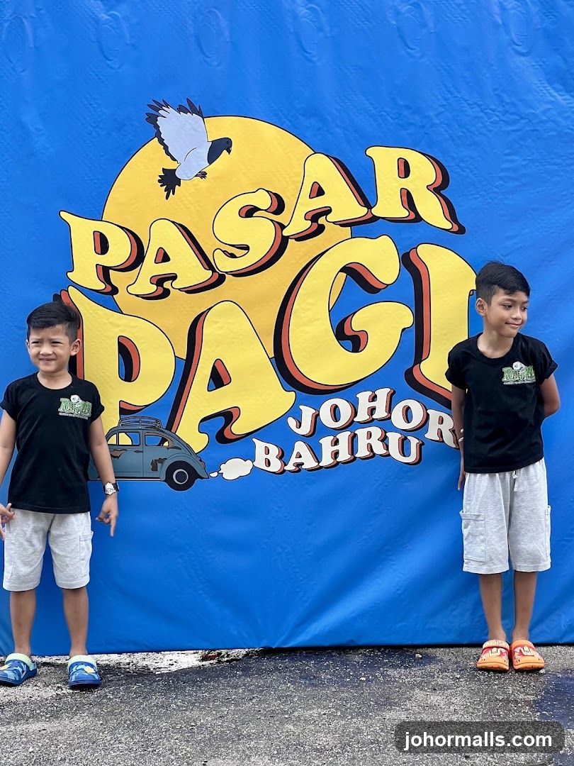 Two boys in front of a blue banner