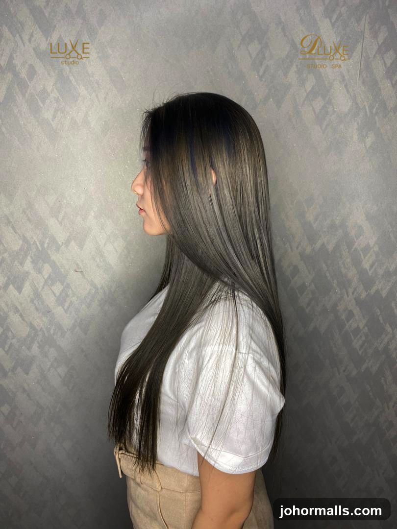 Woman with long, straight, ash-toned hair