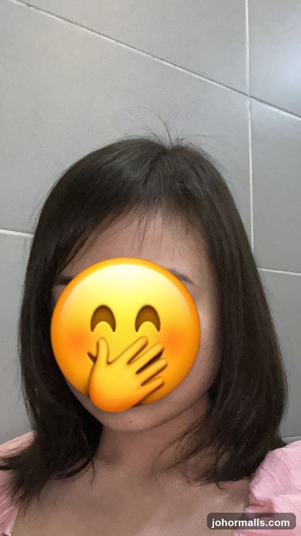 Person covering mouth with emoji