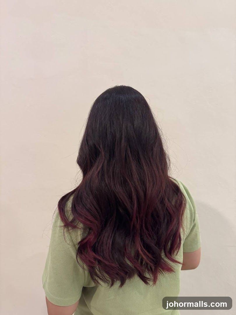 Woman with dark hair with burgundy highlights