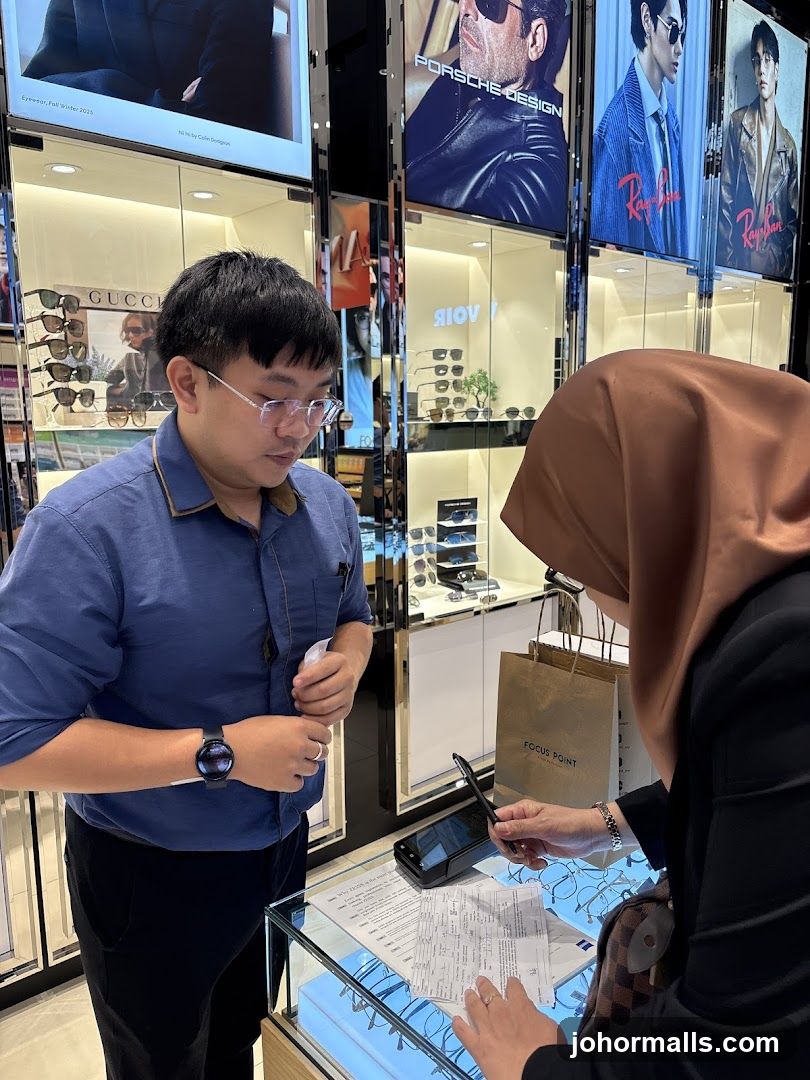 Optician assisting customer