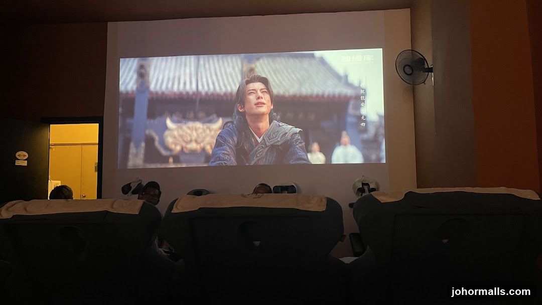 People watching a movie in a dimly lit room