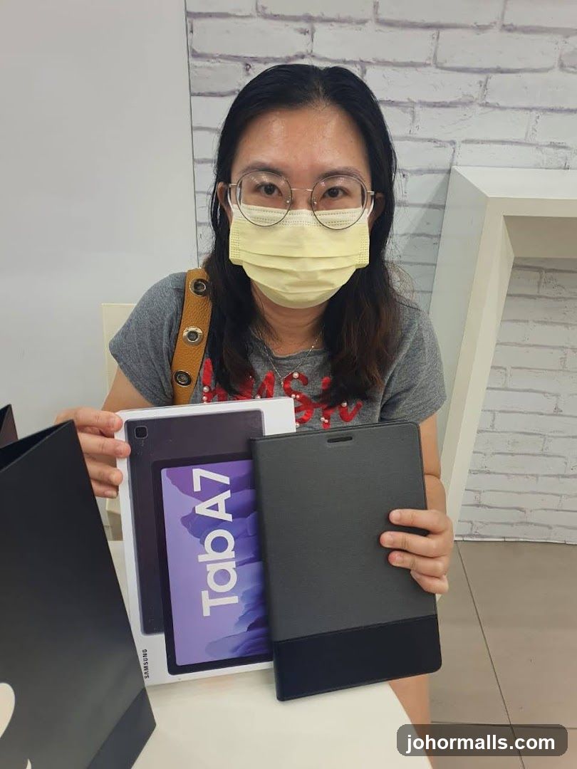 Woman holding a Samsung tablet and case