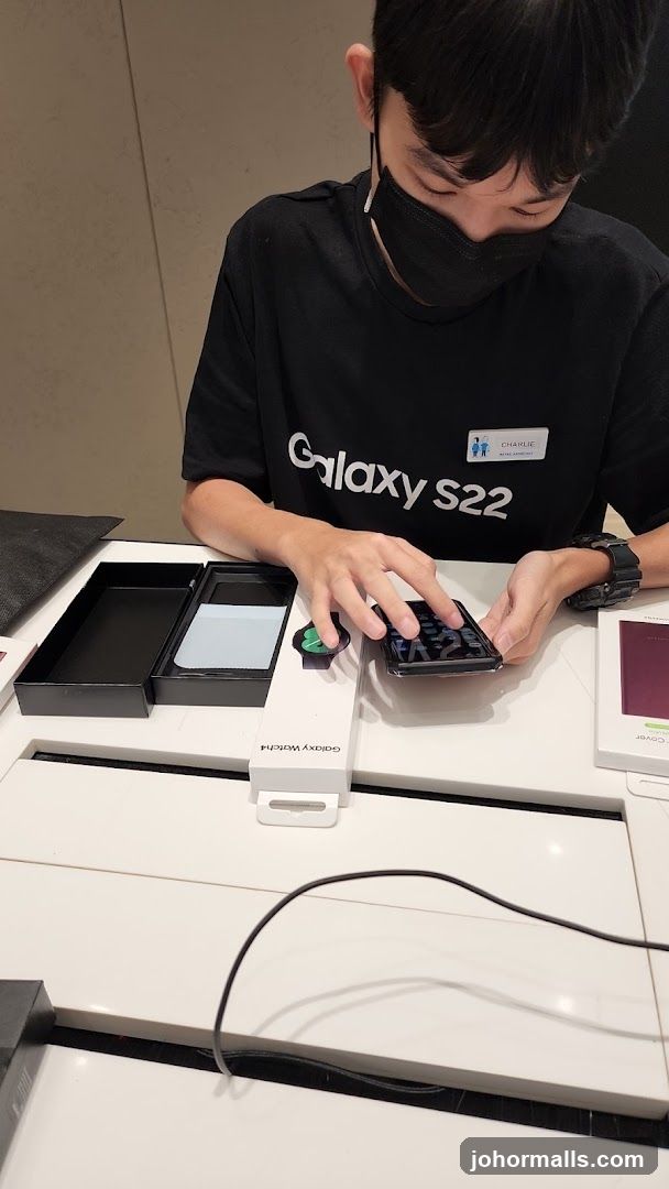Retail assistant demonstrating a smartphone