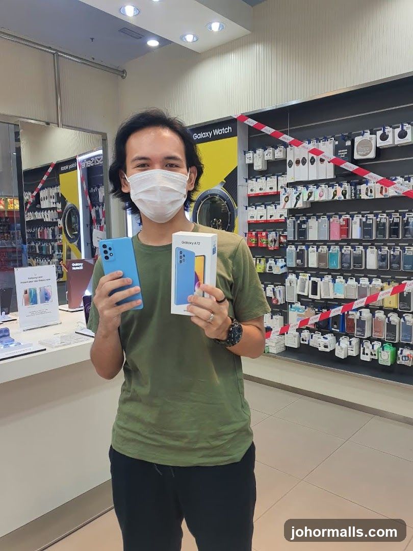 Man holding a new phone and box