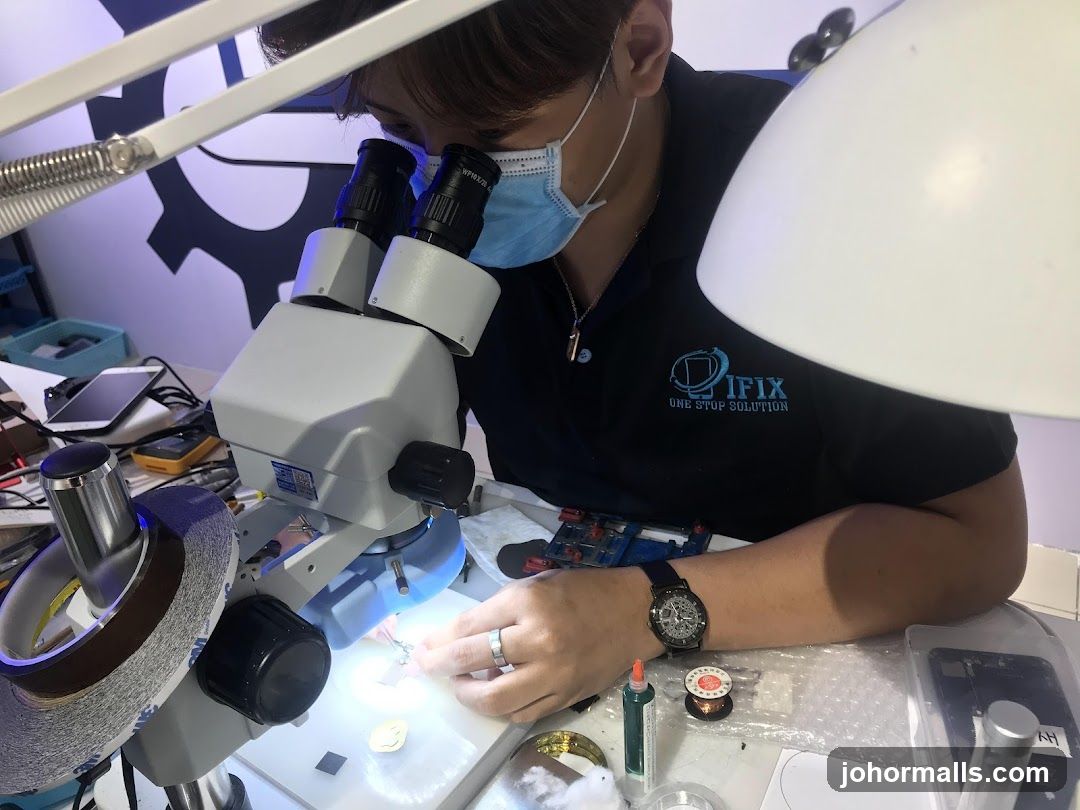 Technician working under a microscope