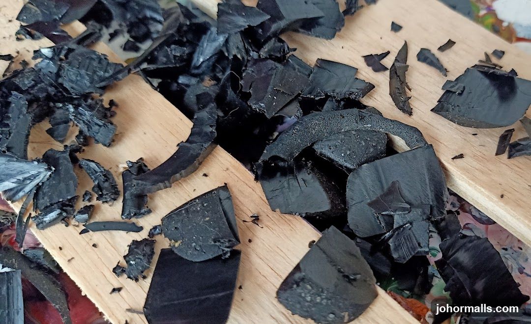 Broken Black Material on Wood