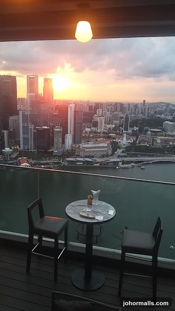 Rooftop Bar Seating with City Sunset View