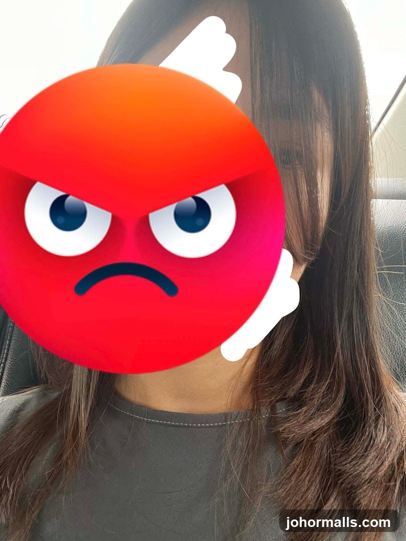 Person with emoji covering face
