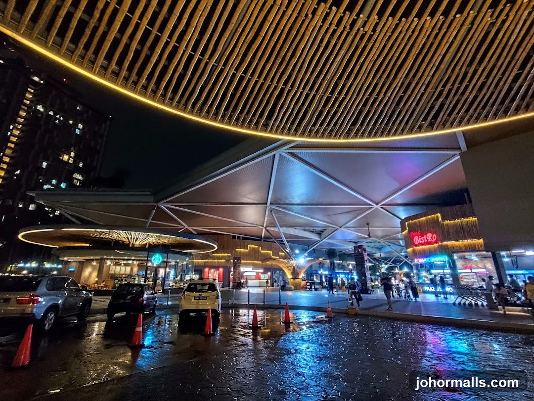 Nighttime view of a modern outdoor shopping area