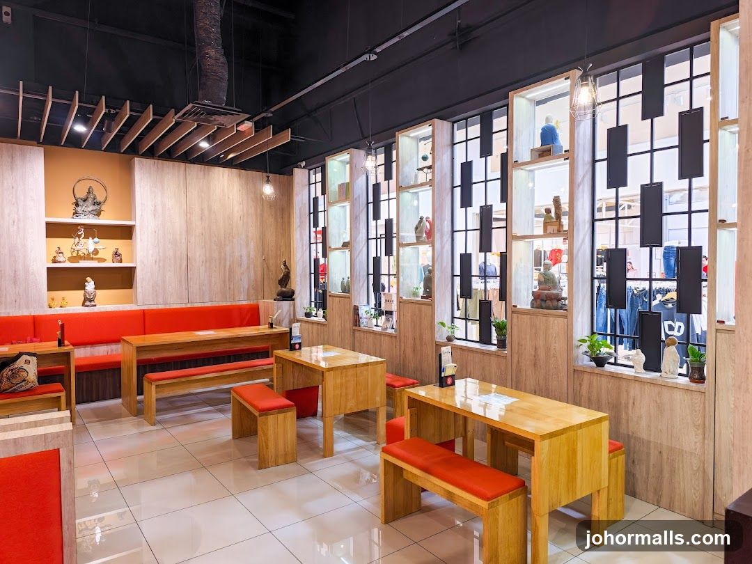 Modern cafe interior with wooden tables and orange seating