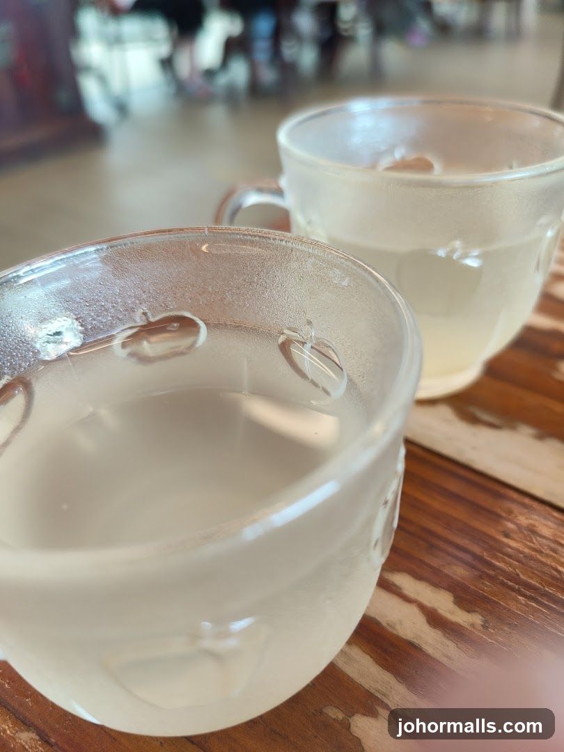 Two frosted glass cups with clear liquid