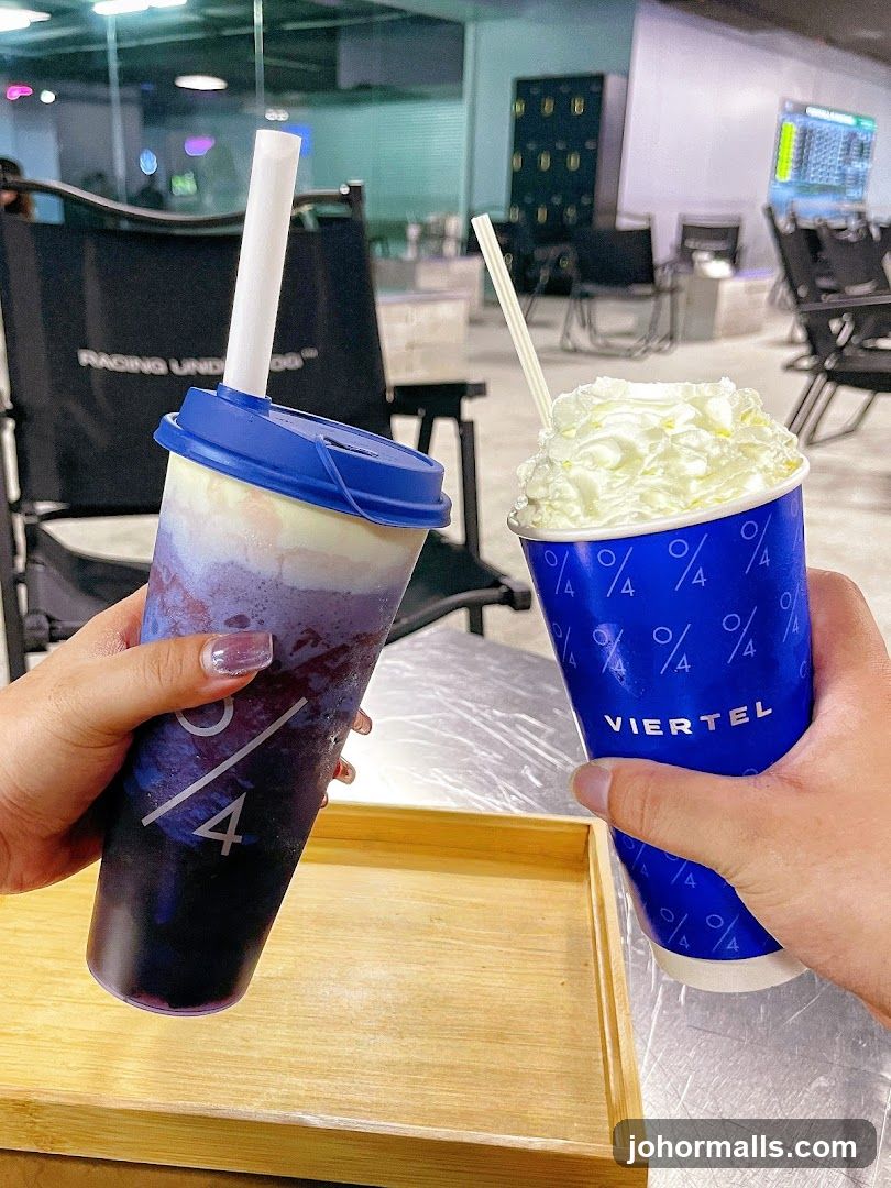 Two drinks with whipped cream and a purple beverage