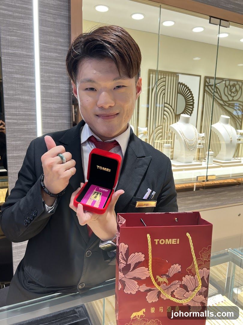 Jewelry store employee with gift box and bag