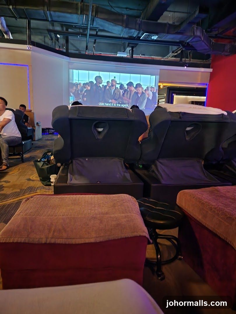Relaxation area with massage chairs and a projector screen