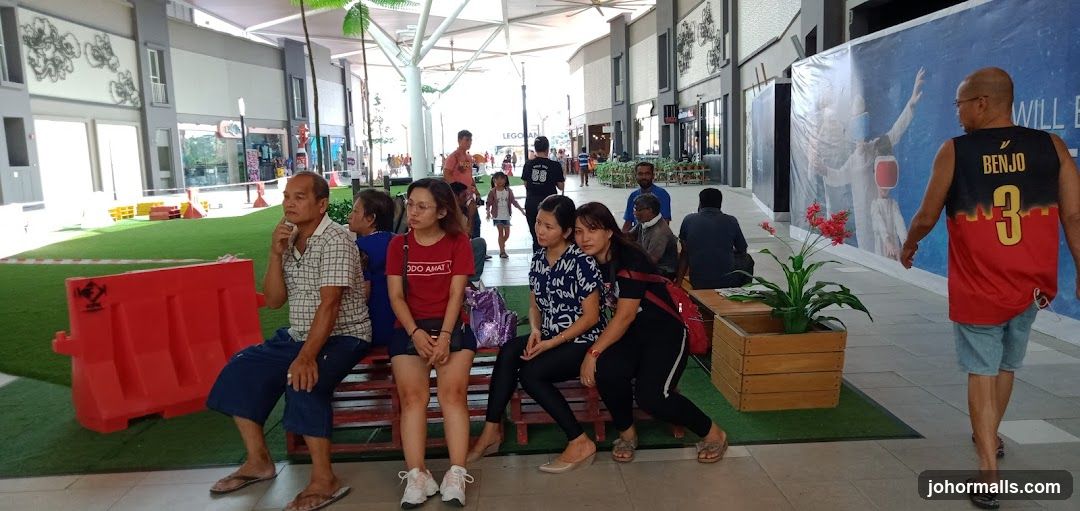 People sitting and walking in an outdoor mall