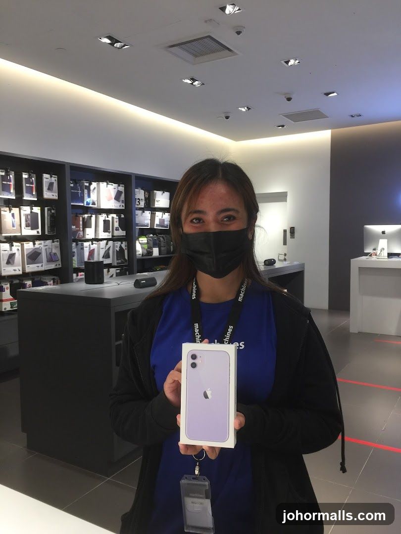 Employee holding an iPhone box