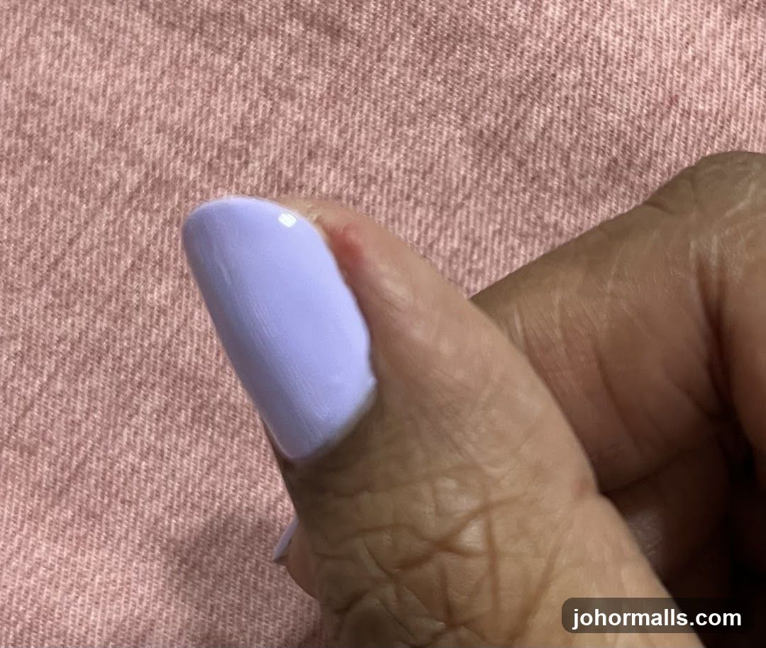 Thumb with Lavender Nail Polish