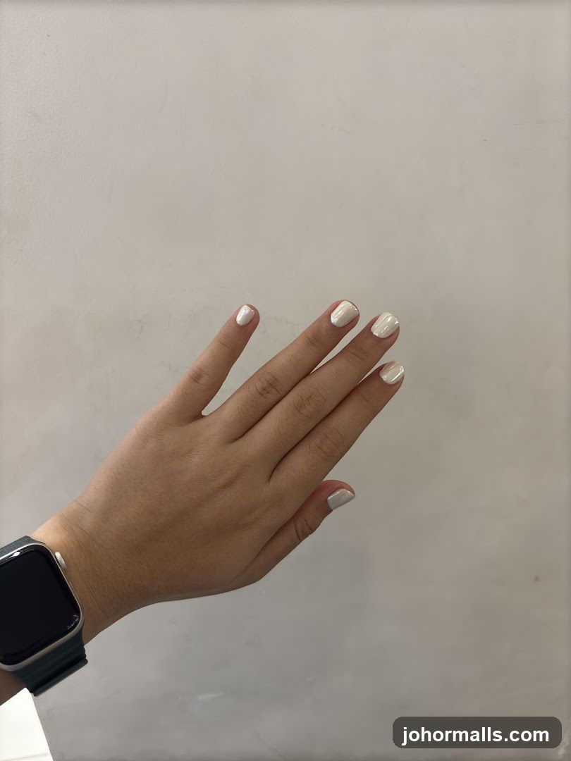 Hand with white nail polish