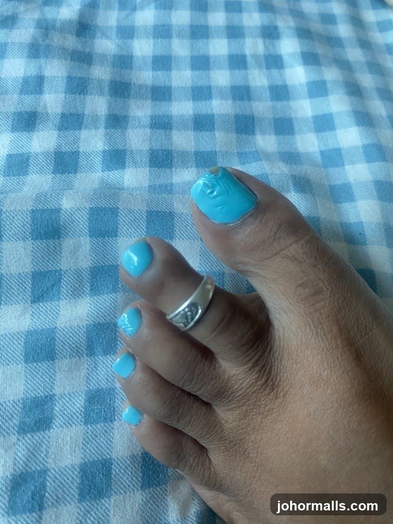 Toes with Blue Nail Polish and Ring