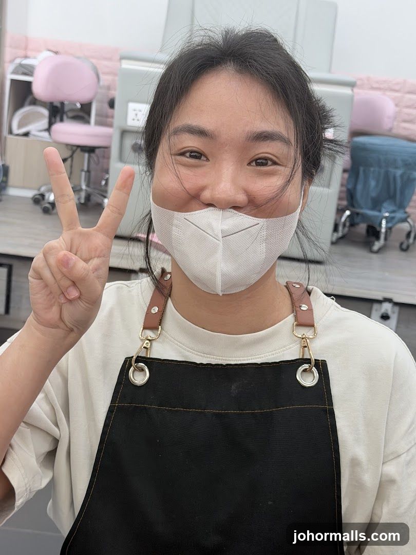 Woman in an apron making a peace sign