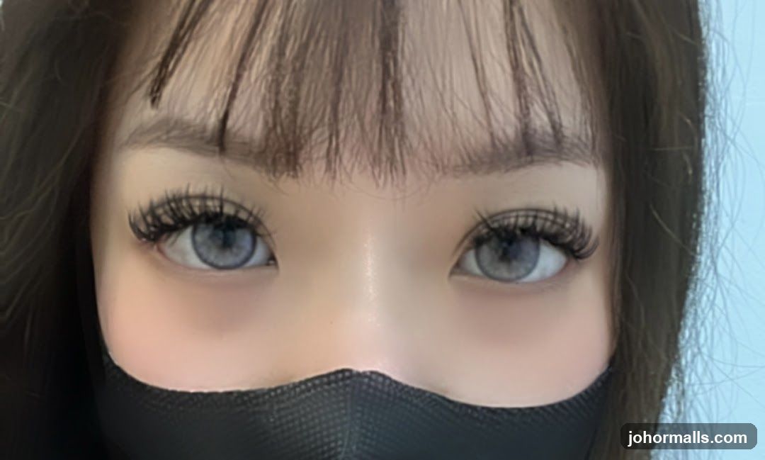Close-up of eyes with false eyelashes and a face mask