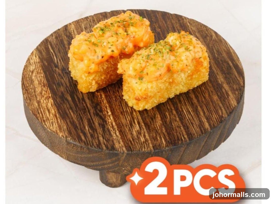 Two pieces of fried food with sauce