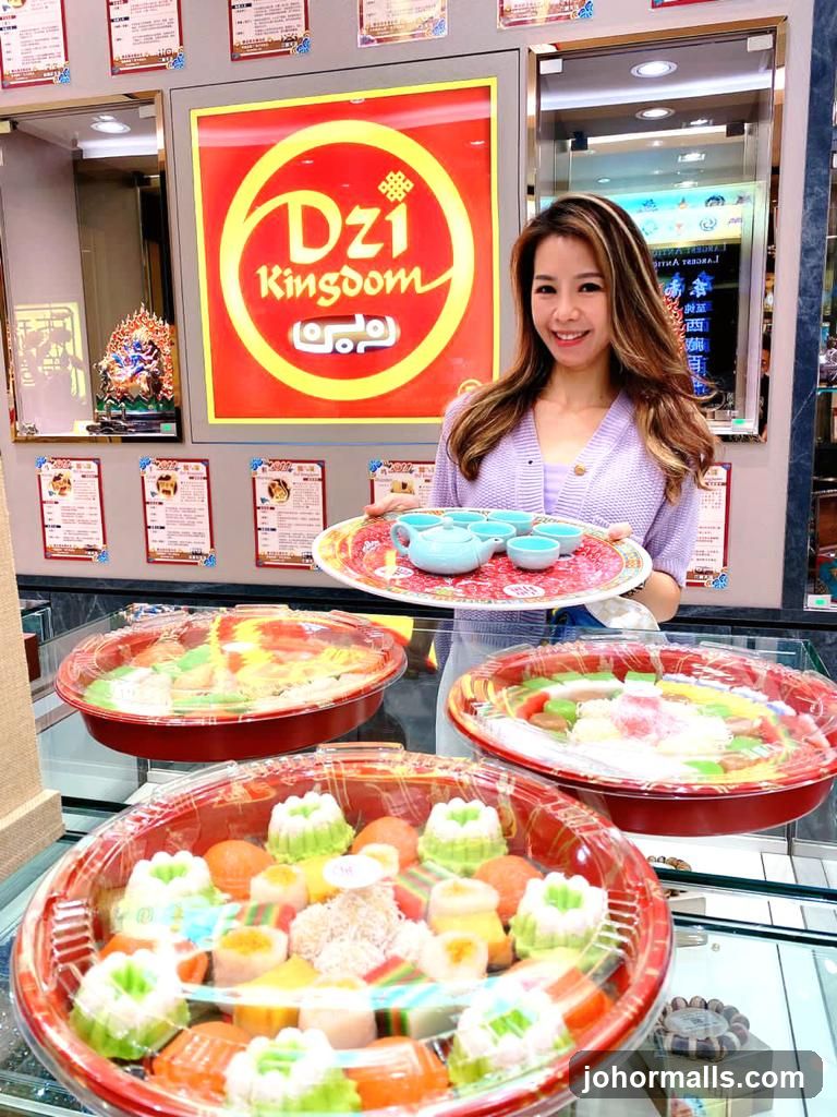 Woman holding a tray of tea cups and a display of desserts