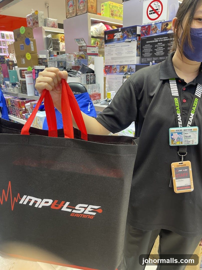 Employee holding a branded shopping bag