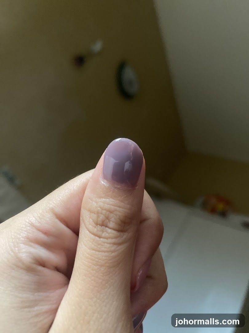 Thumb with Purple Nail Polish