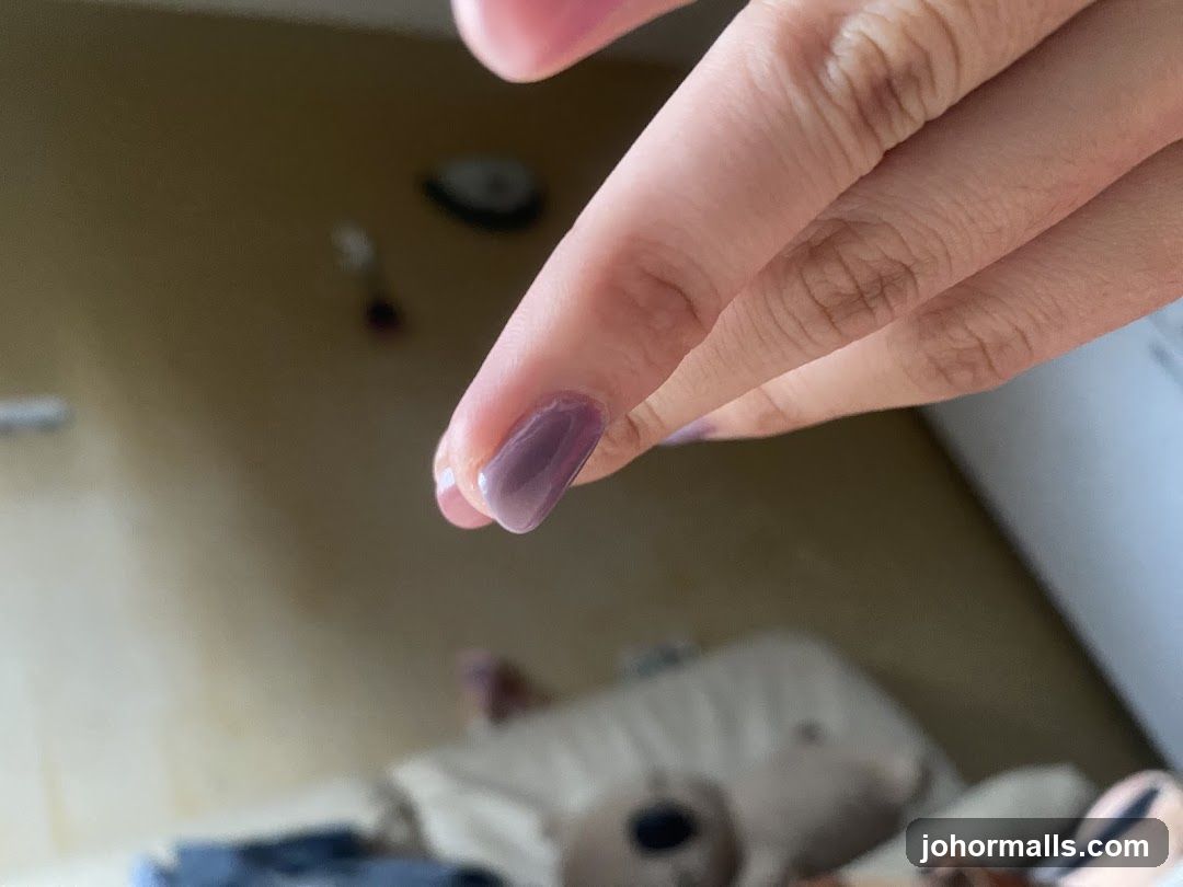 Close-up of a hand with purple nail polish