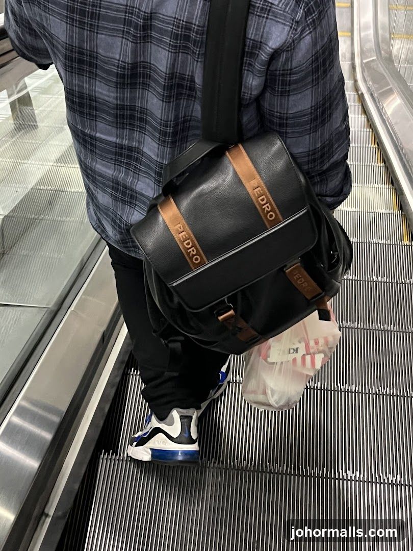 Person on Escalator with Backpack
