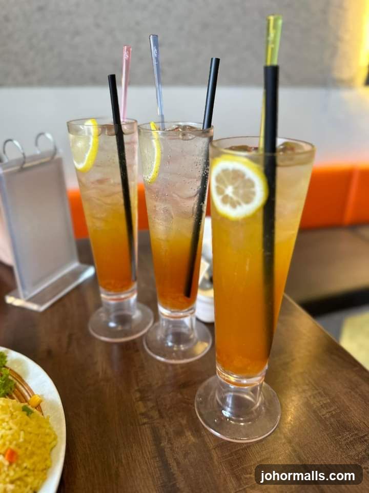 Three iced drinks with lemon slices